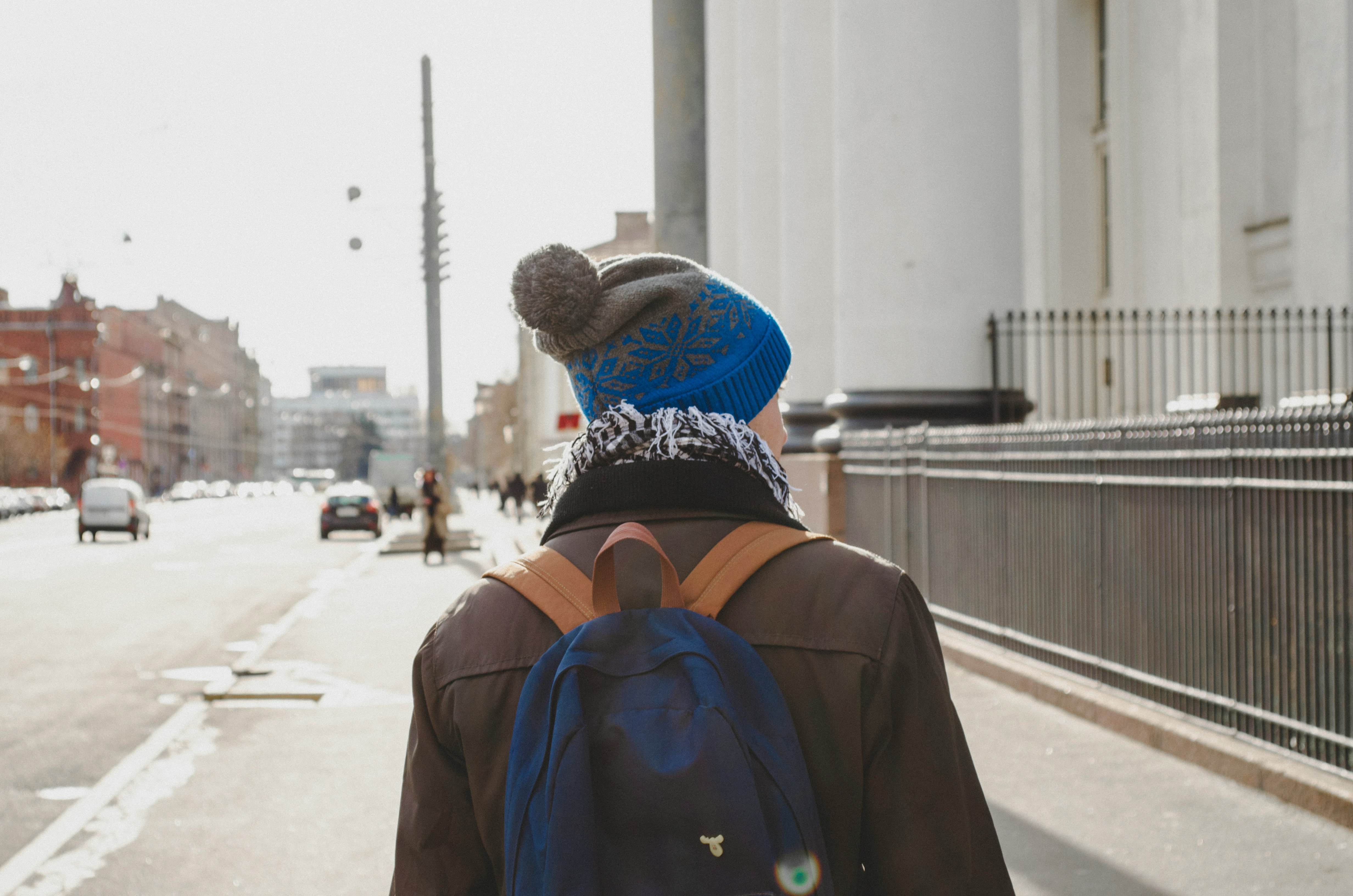 person in brown jacket wearing brown and black hat